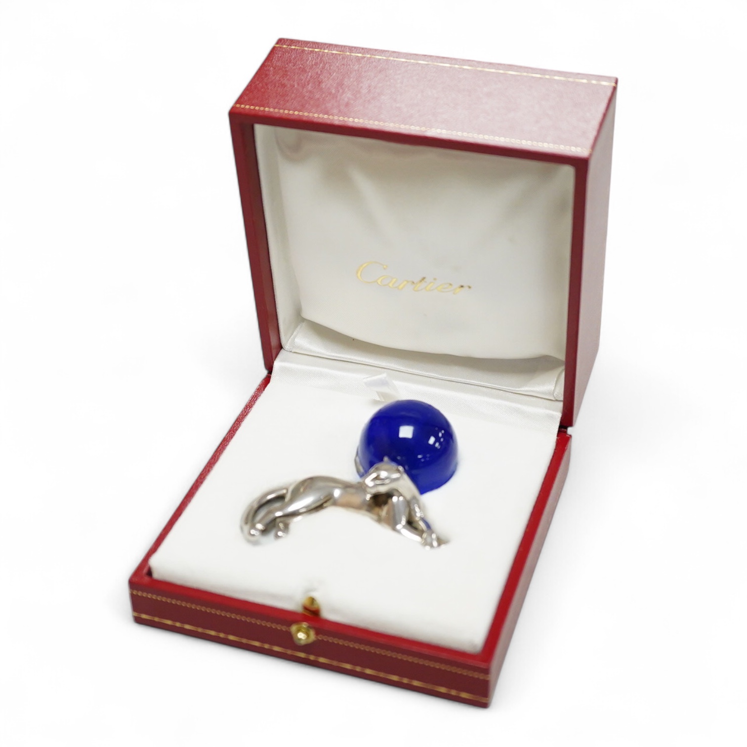 A recent Cartier paperweight, modelled as a recumbent 925 panther with blue glass sphere(a.f.), signed, in original fitted Cartier box, 56mm by 60mm.